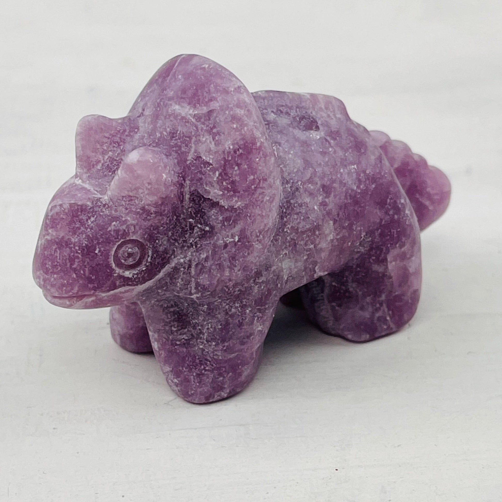 close up of the details on the carved gemstone dinosaur
