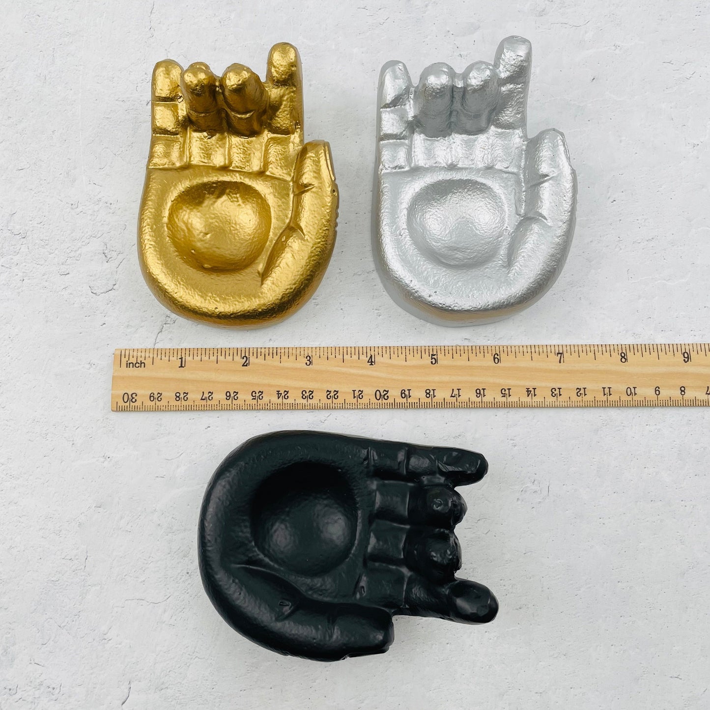 sphere holder next to a ruler for size reference 