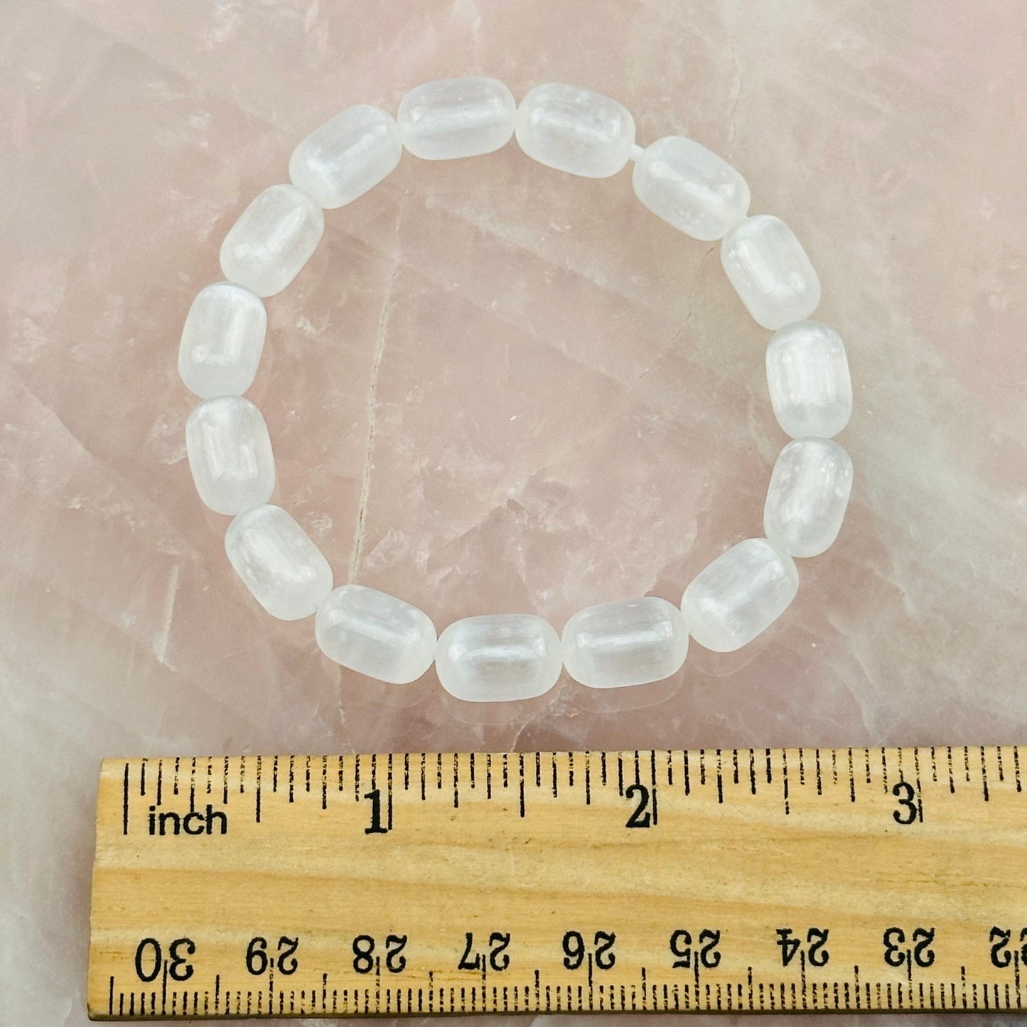 bracelet next to a ruler for size reference 