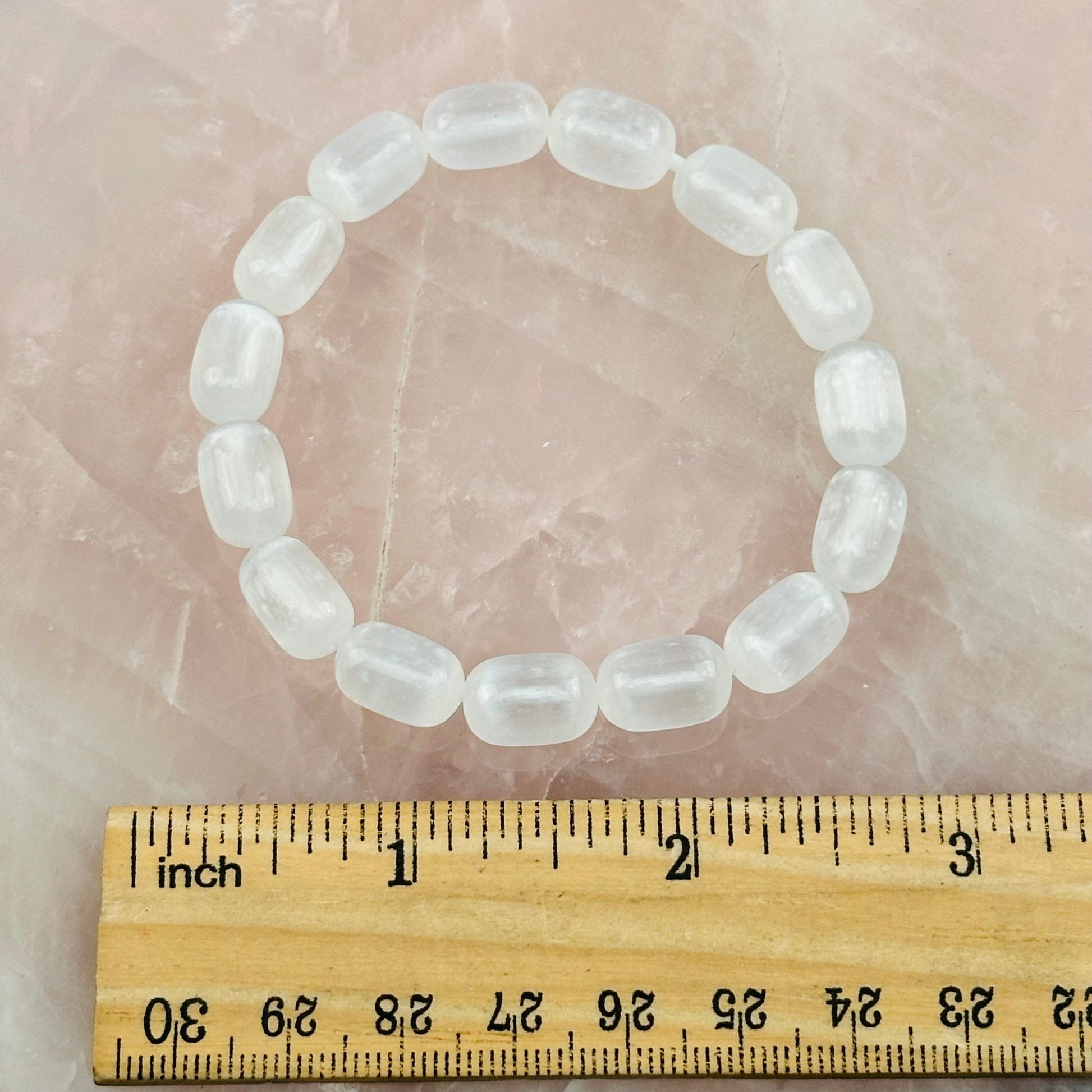 bracelet next to a ruler for size reference 
