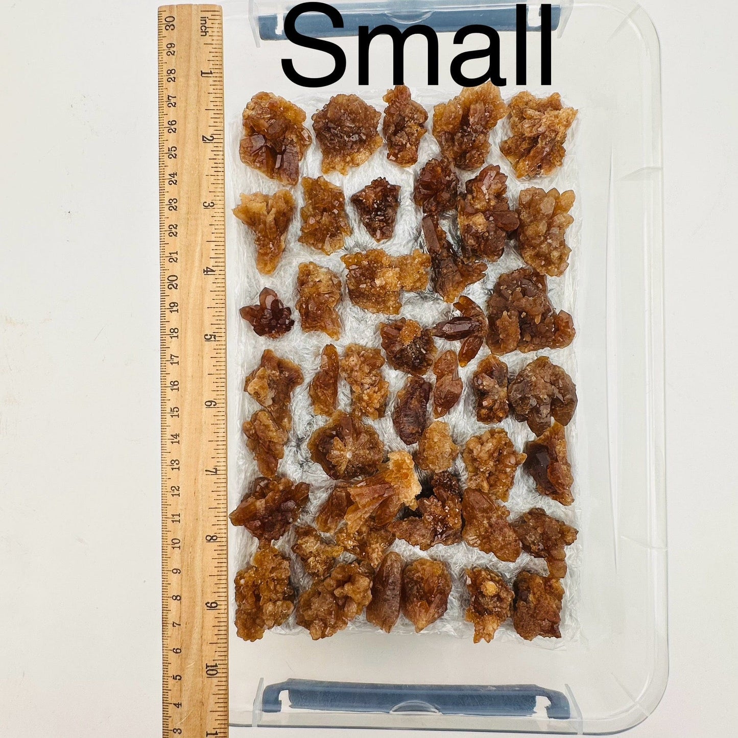 natural citrine crystal clusters are sold by the flat. Small option displayed by a ruler for size reference 