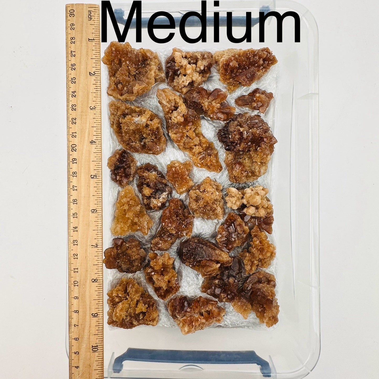 natural citrine crystal clusters are sold by the flat. Medium option displayed by a ruler for size reference 