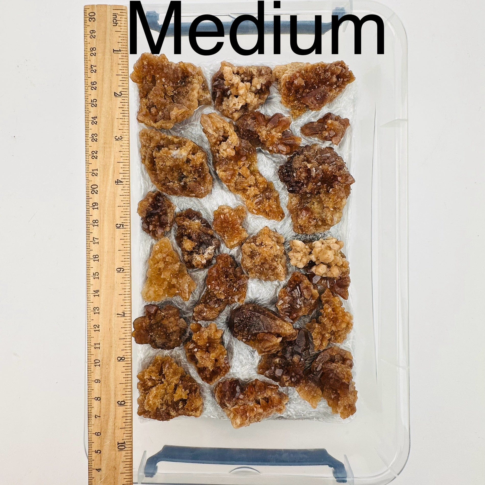 natural citrine crystal clusters are sold by the flat. Medium option displayed by a ruler for size reference 