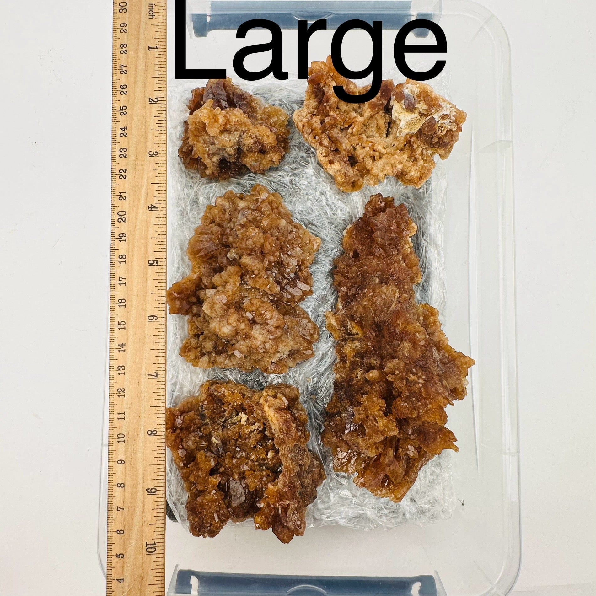 natural citrine crystal clusters are sold by the flat. Large option displayed by a ruler for size reference 