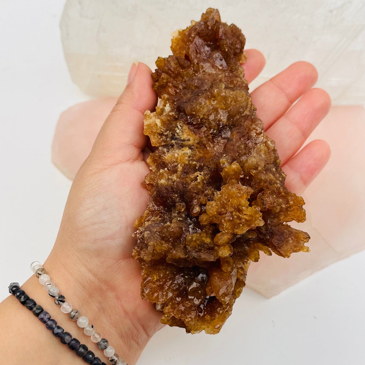 large natural citrine crystal cluster in hand for size reference 