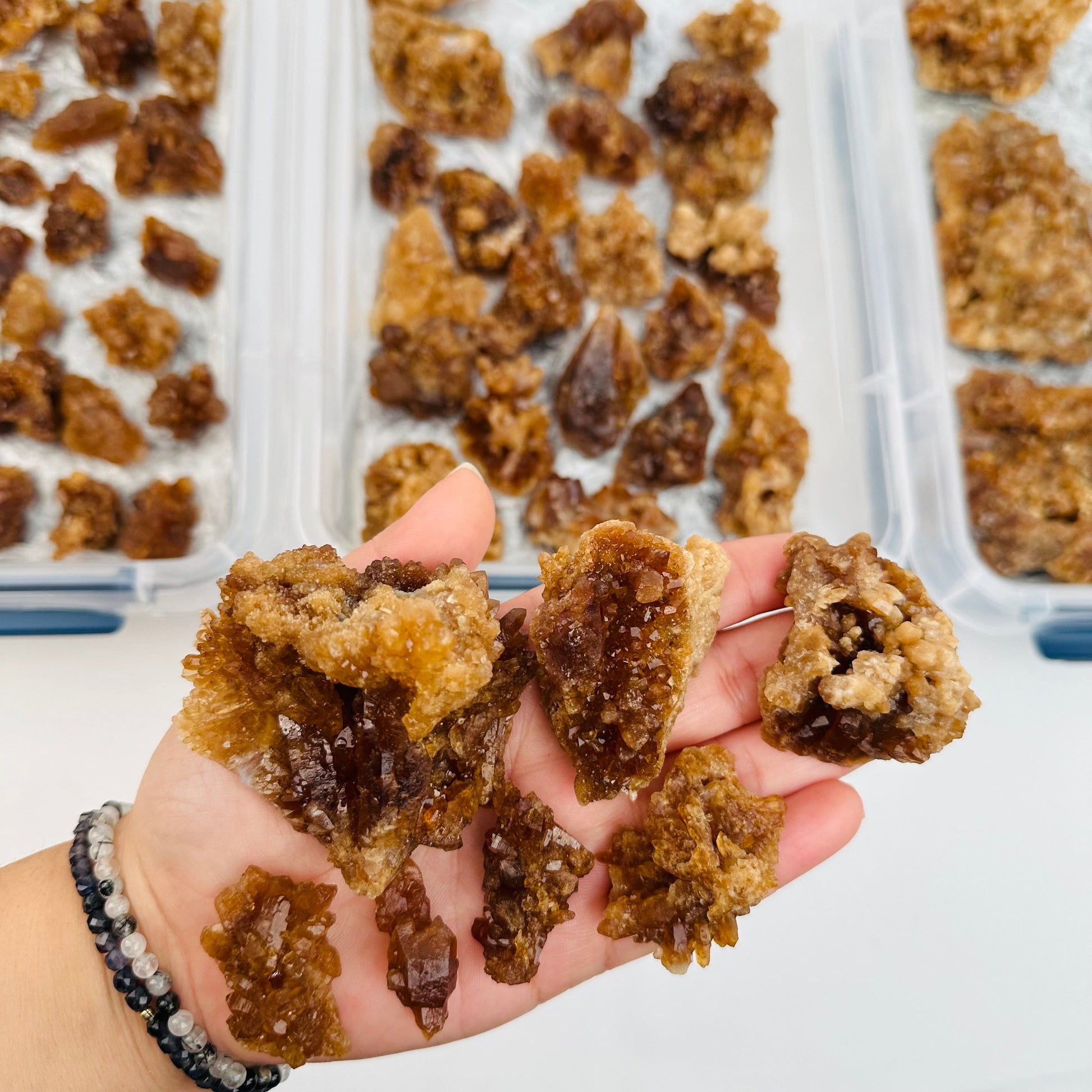 multiple natural citrine cluster in hand for size reference 