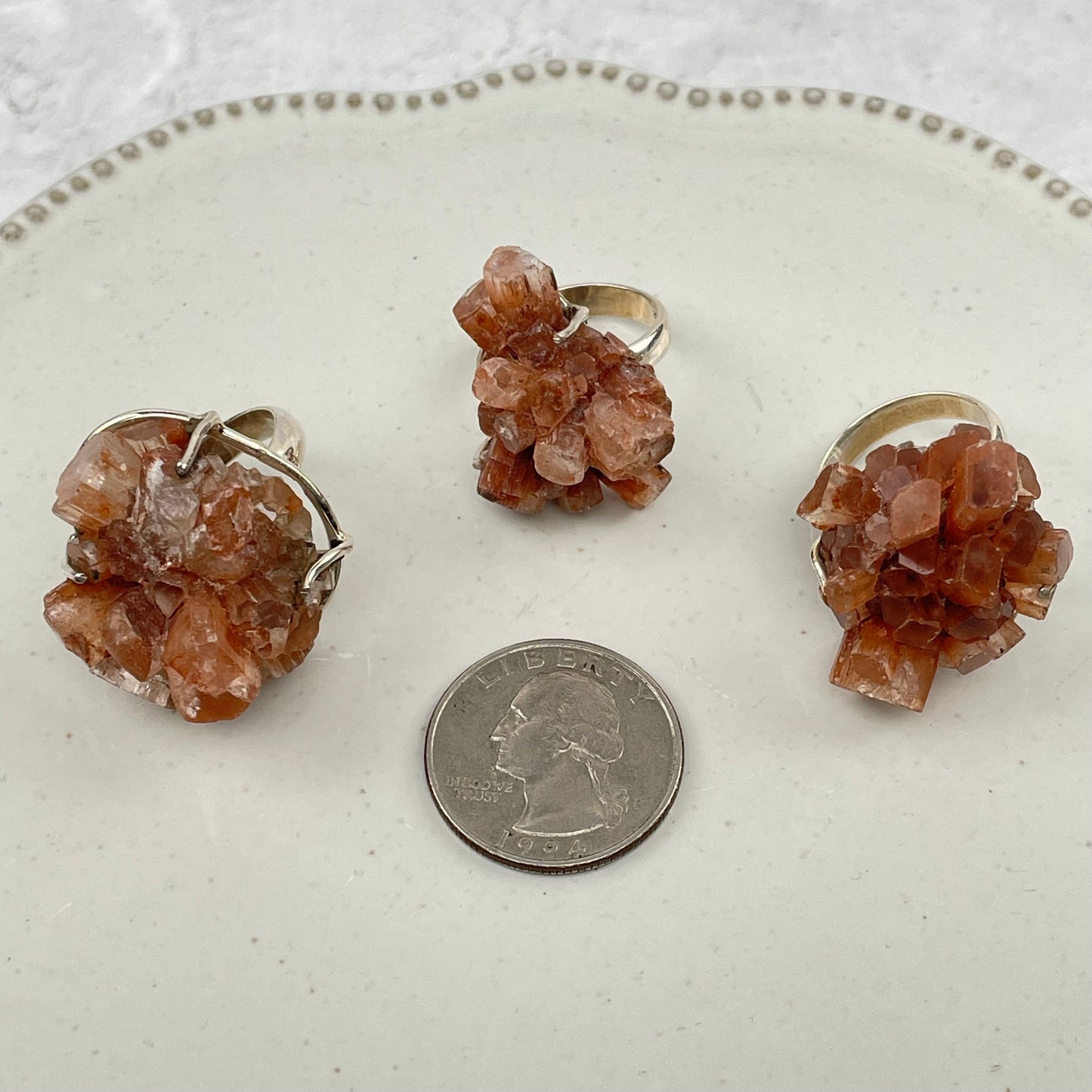 rings next to a quarter for size reference 