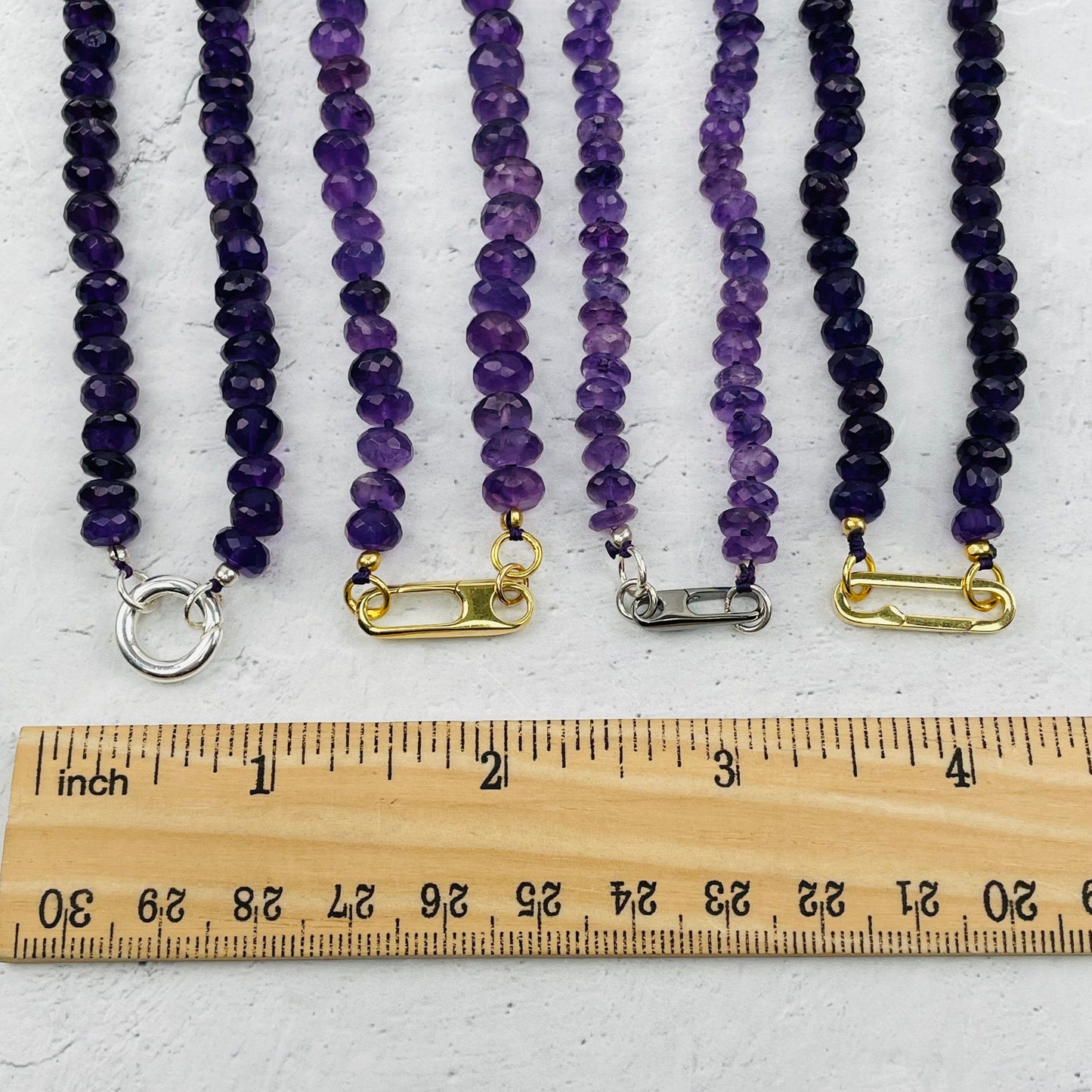 clasps next to a ruler for size reference 