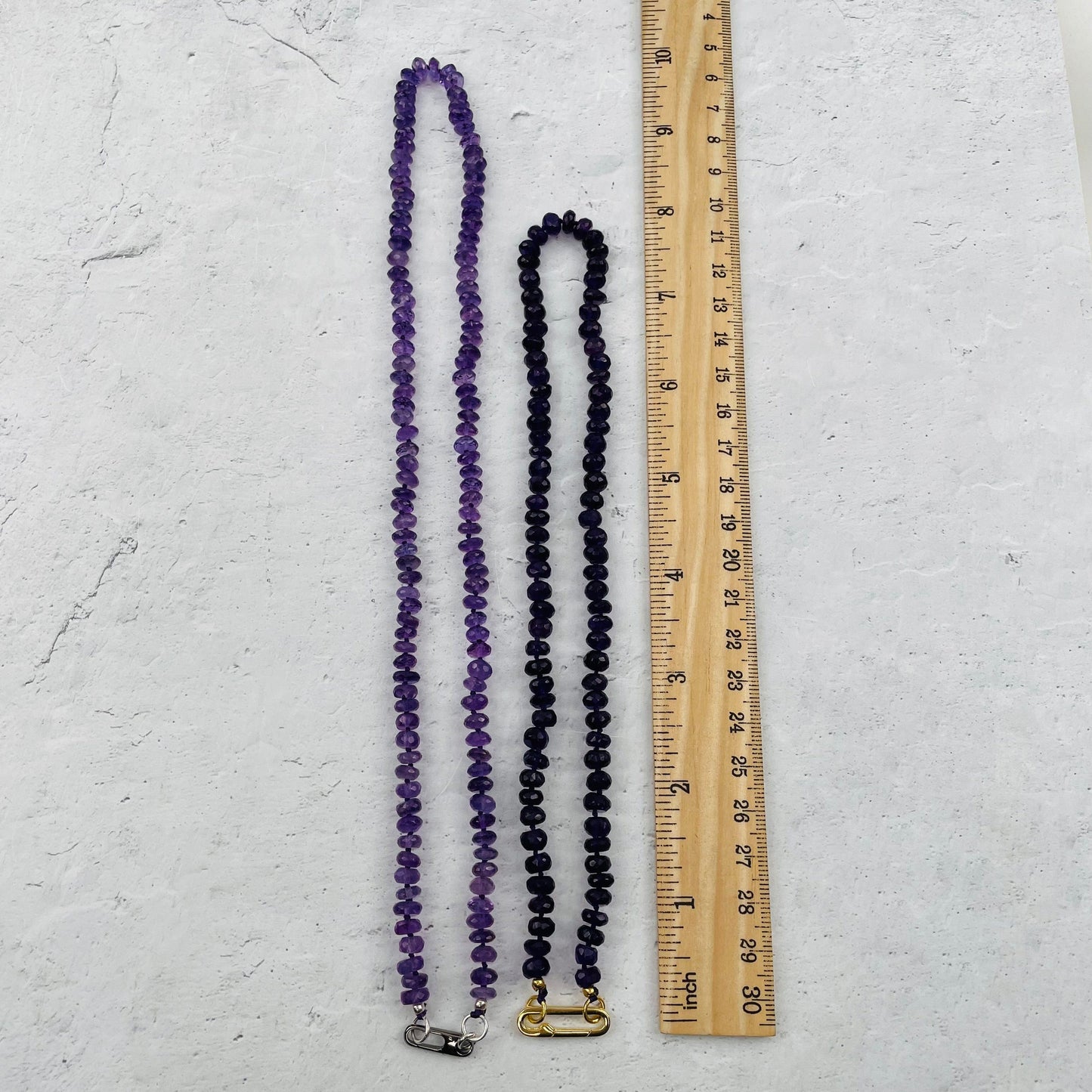necklaces next to a ruler for size reference 
