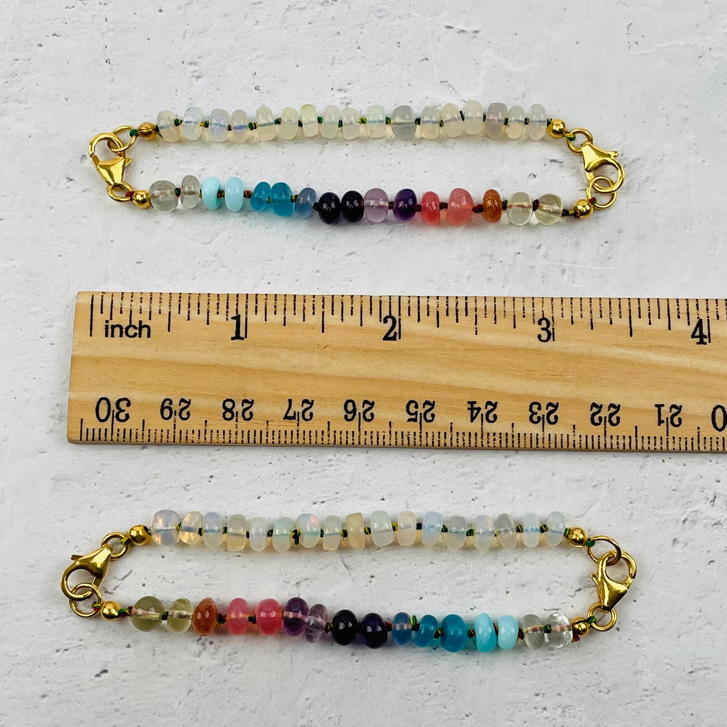 bracelets next to a ruler for size reference 