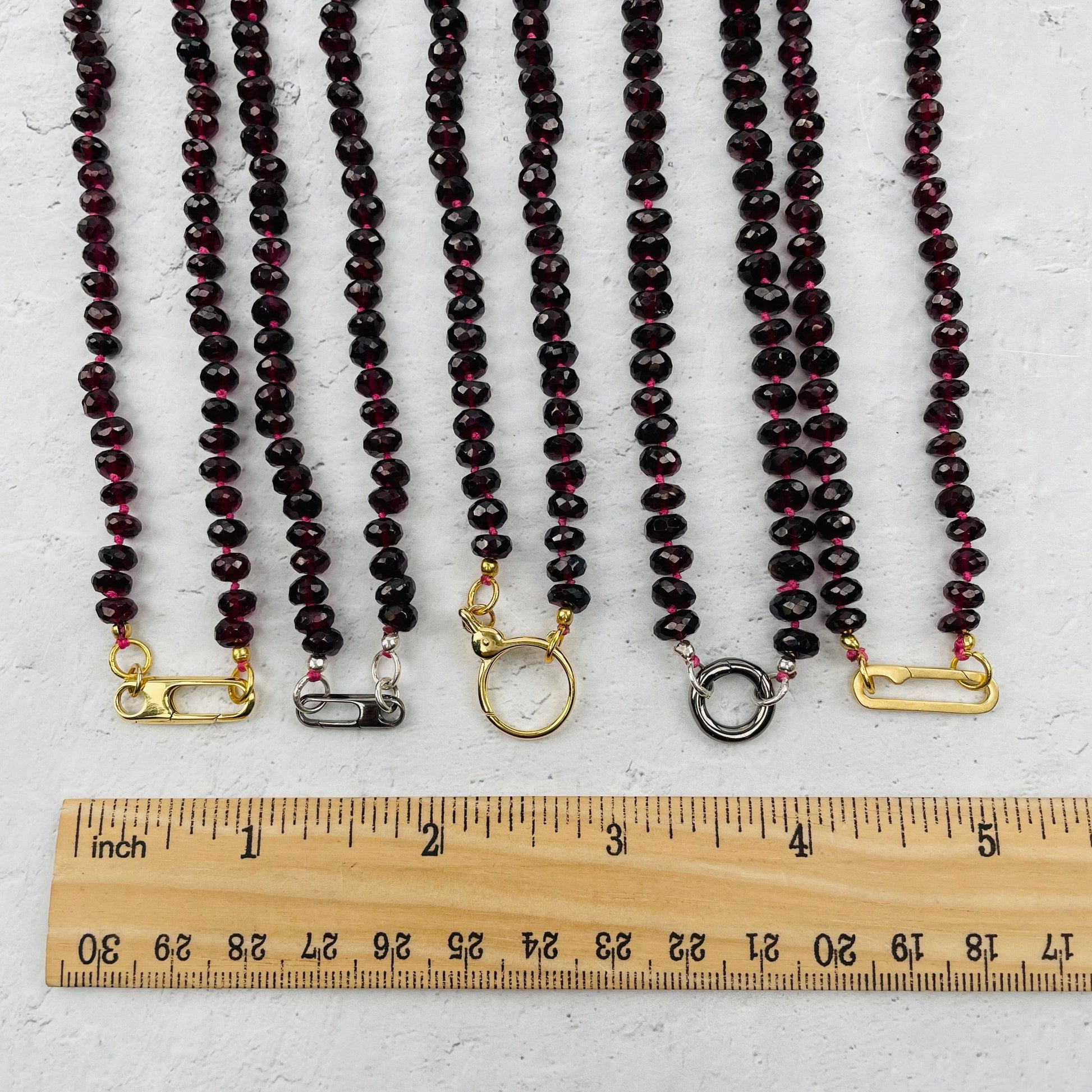 clasps next to a ruler for size reference 