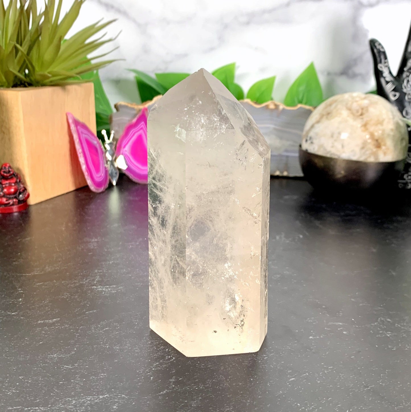 Crystal Quartz Tower Point with decorations in the background