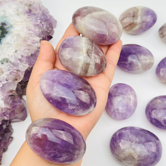 multiple crystal palm stones on hand for size reference 