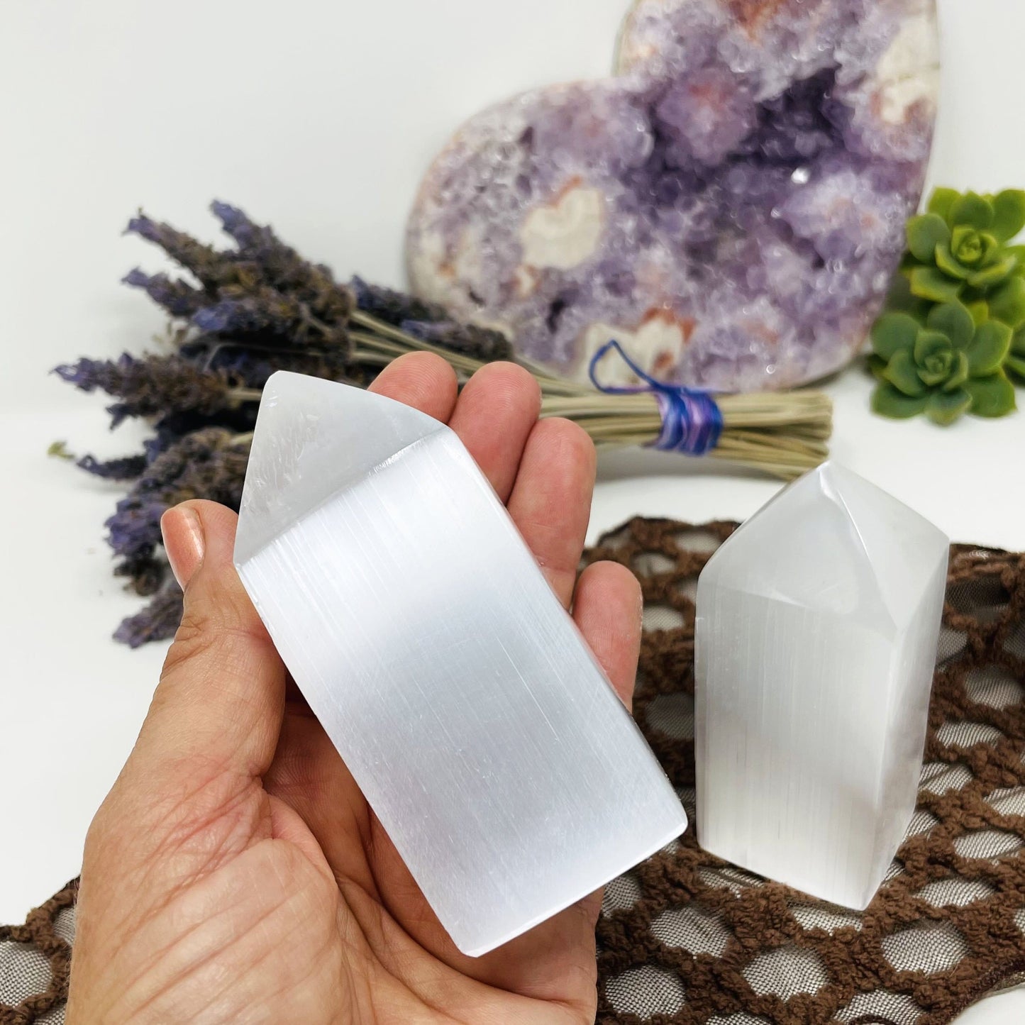 selenite square point in hand for size reference with display