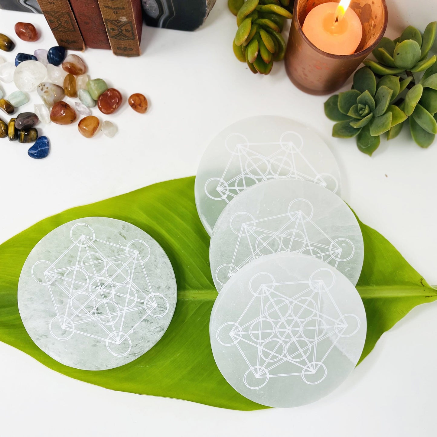 selenite rounds with metatron engraving on display for engraving details and possible variations