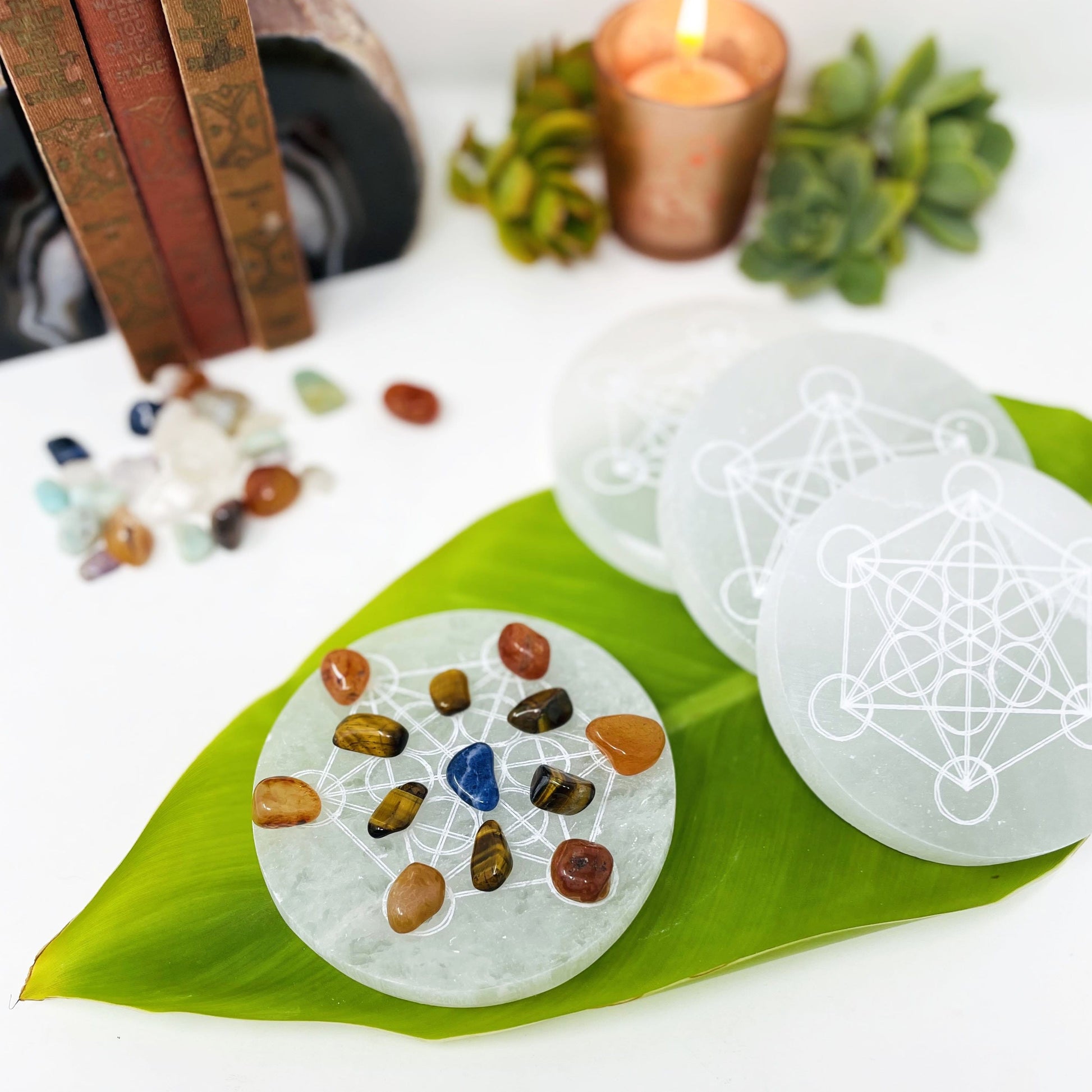 selenite rounds with metatron engraving with charging stones and others on display