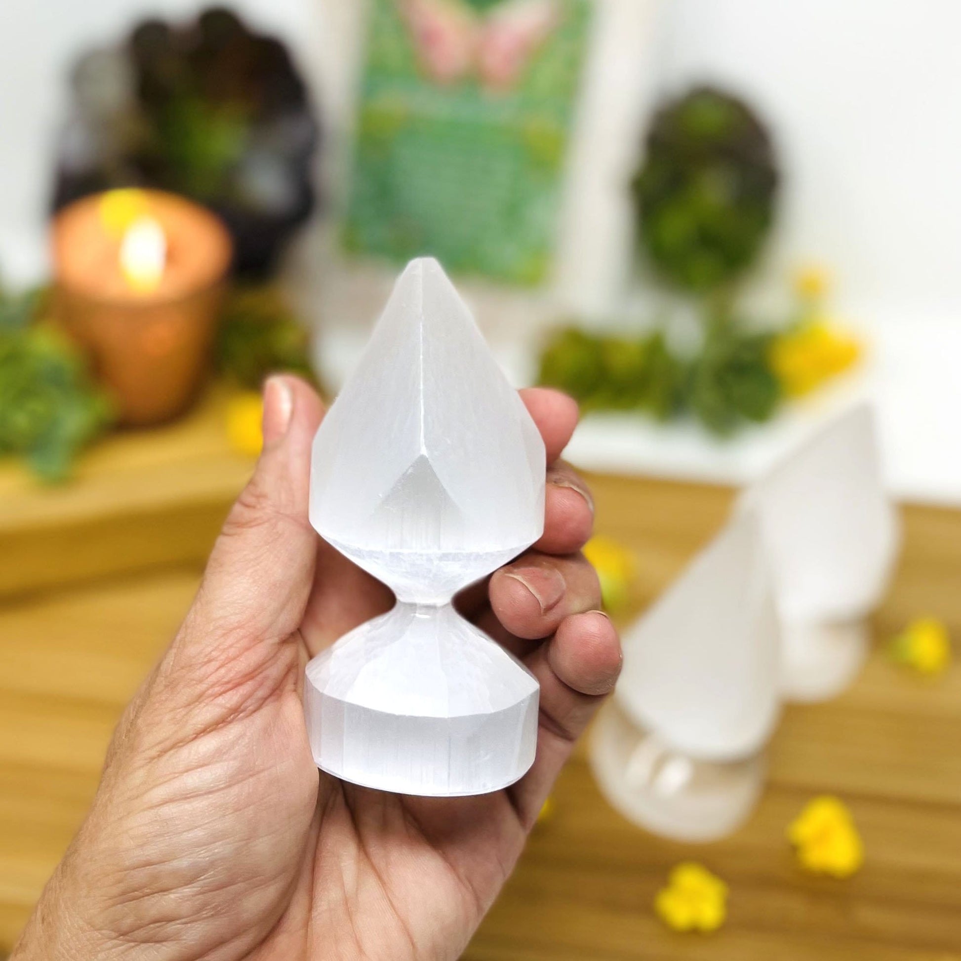 selenite round spear tips in hand for size reference