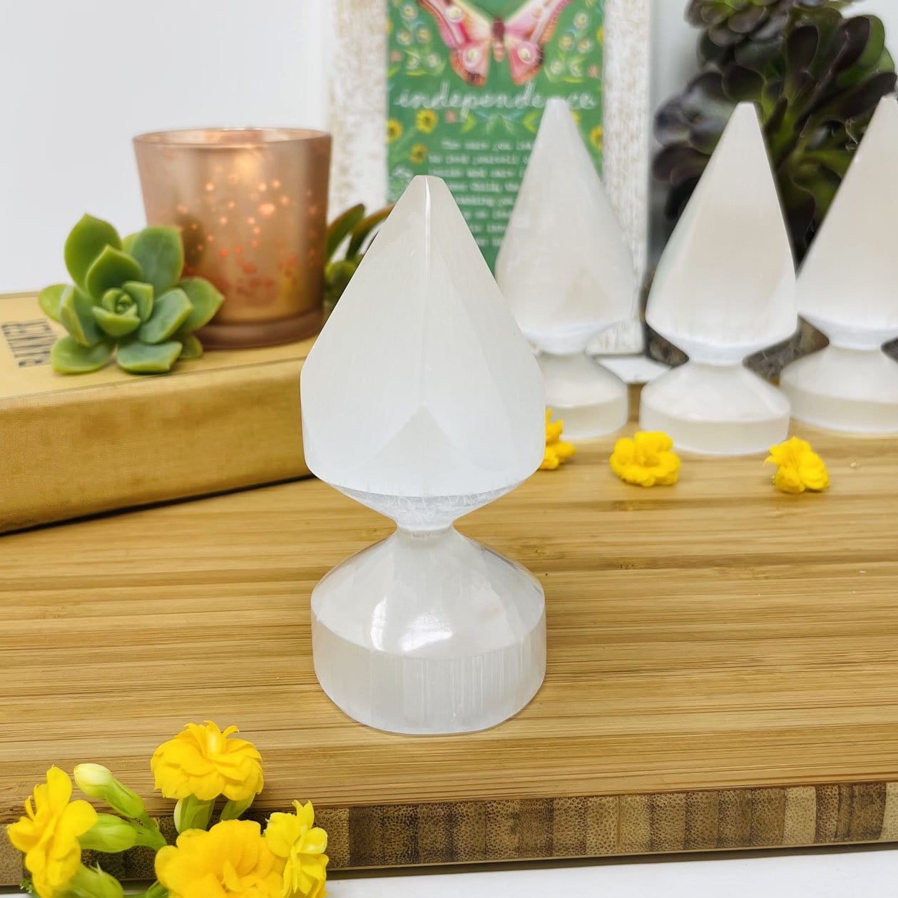 close up of one selenite spear tip for details with others in background display