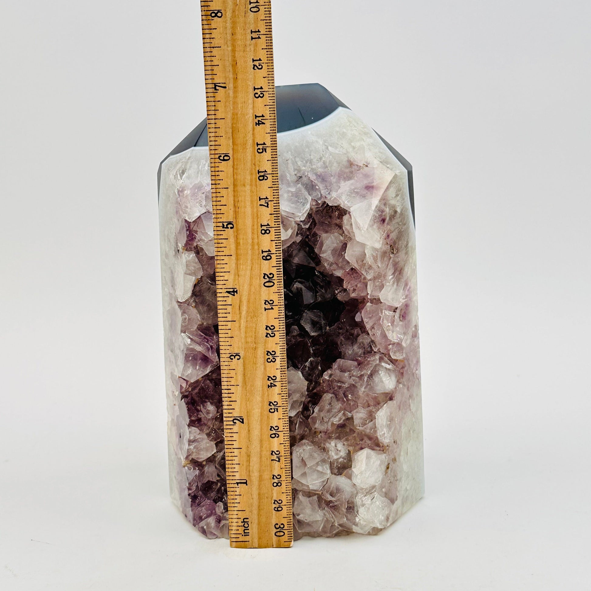 amethyst crystal cut base next to a ruler for size reference 