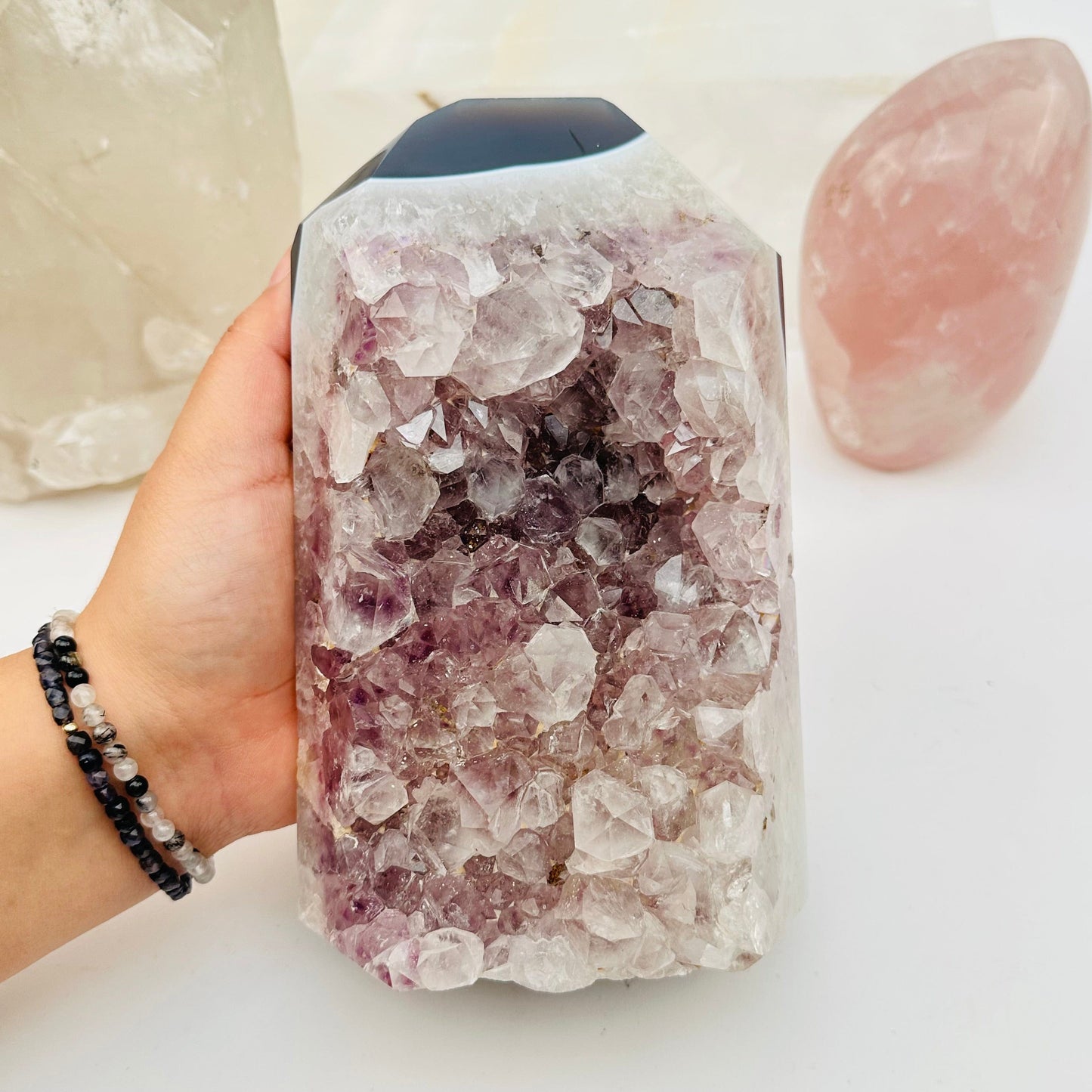amethyst semi polished point in hand for size reference 
