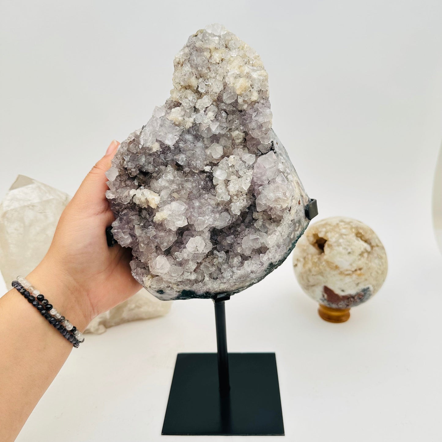 amethyst crystal cluster on hand for size reference 