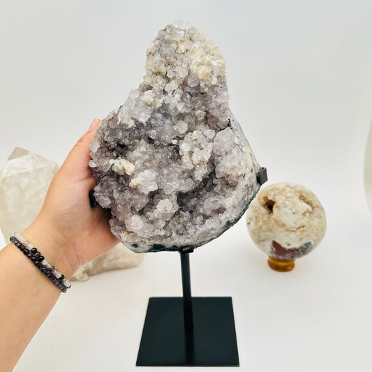 amethyst crystal cluster on hand for size reference 