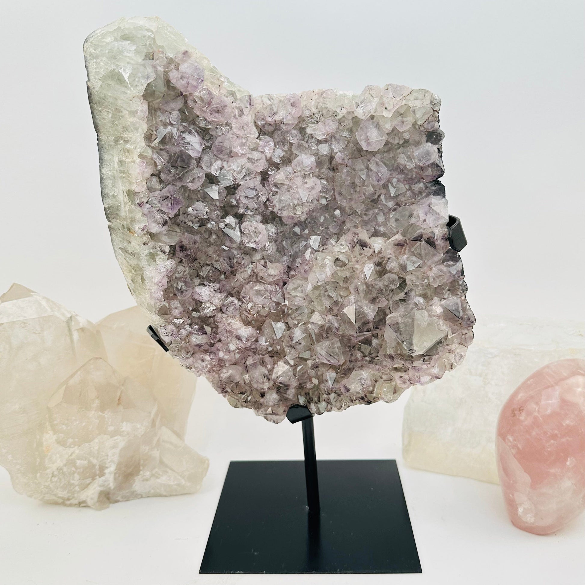amethyst crystal cluster on metal stand displayed as home decor 