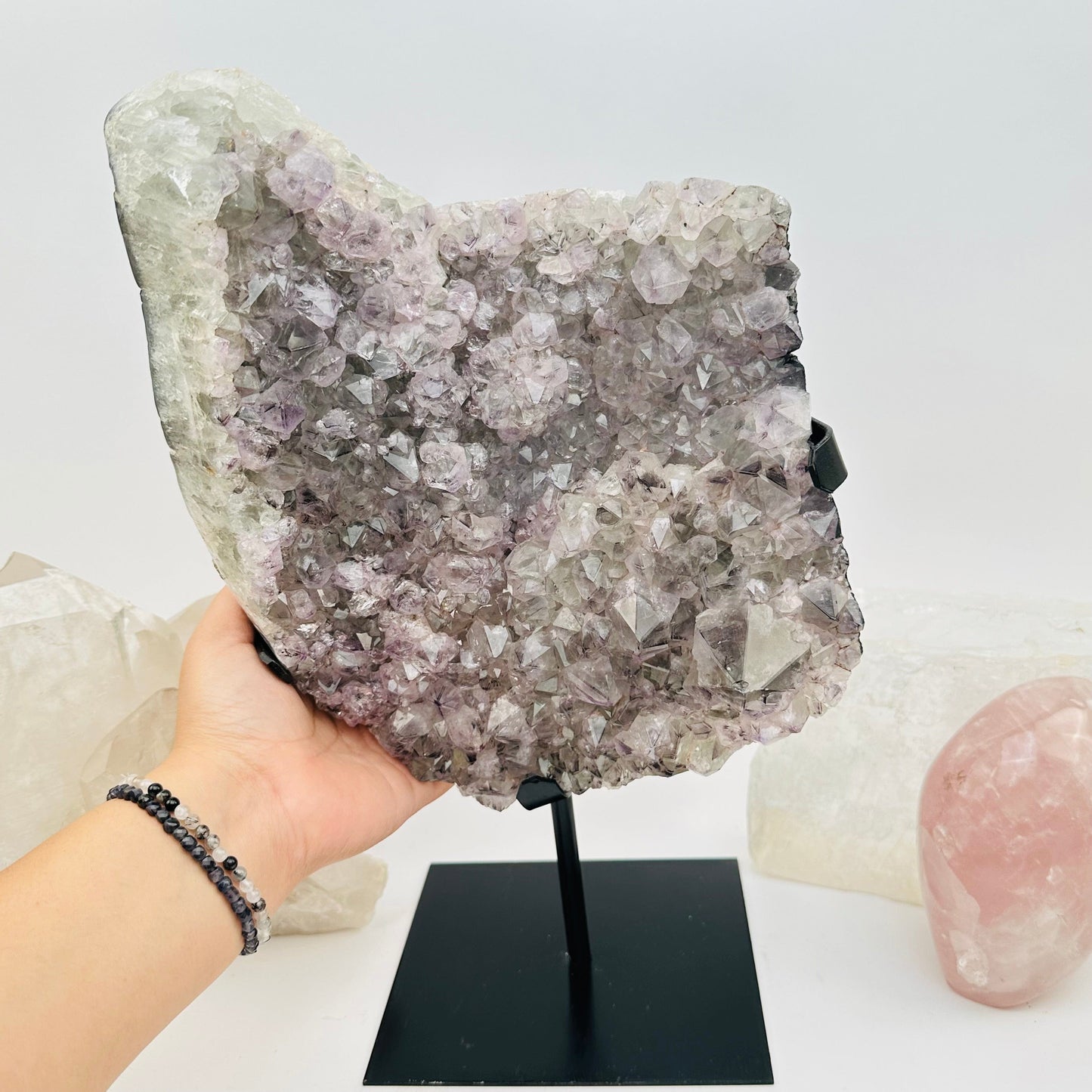 amethyst crystal cluster in hand for size reference 