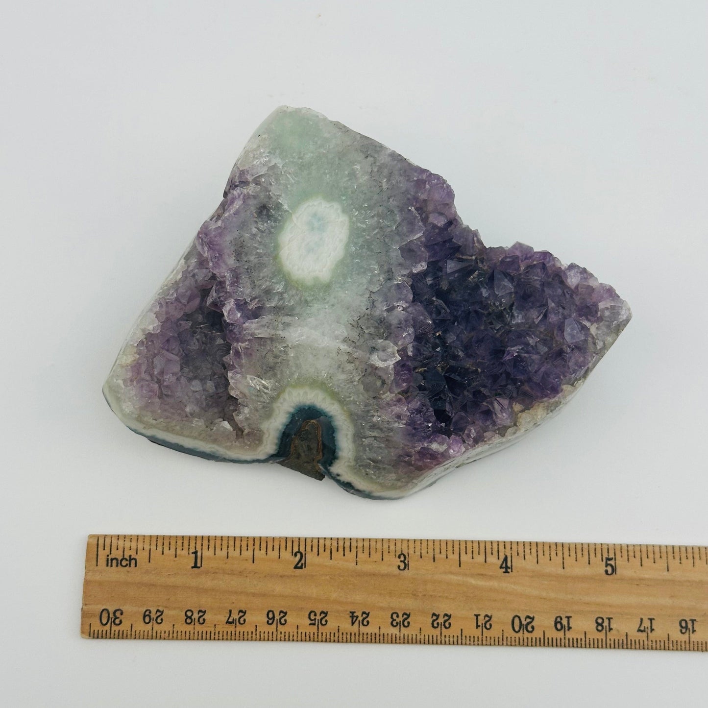 crystal cluster next to a ruler for size reference 