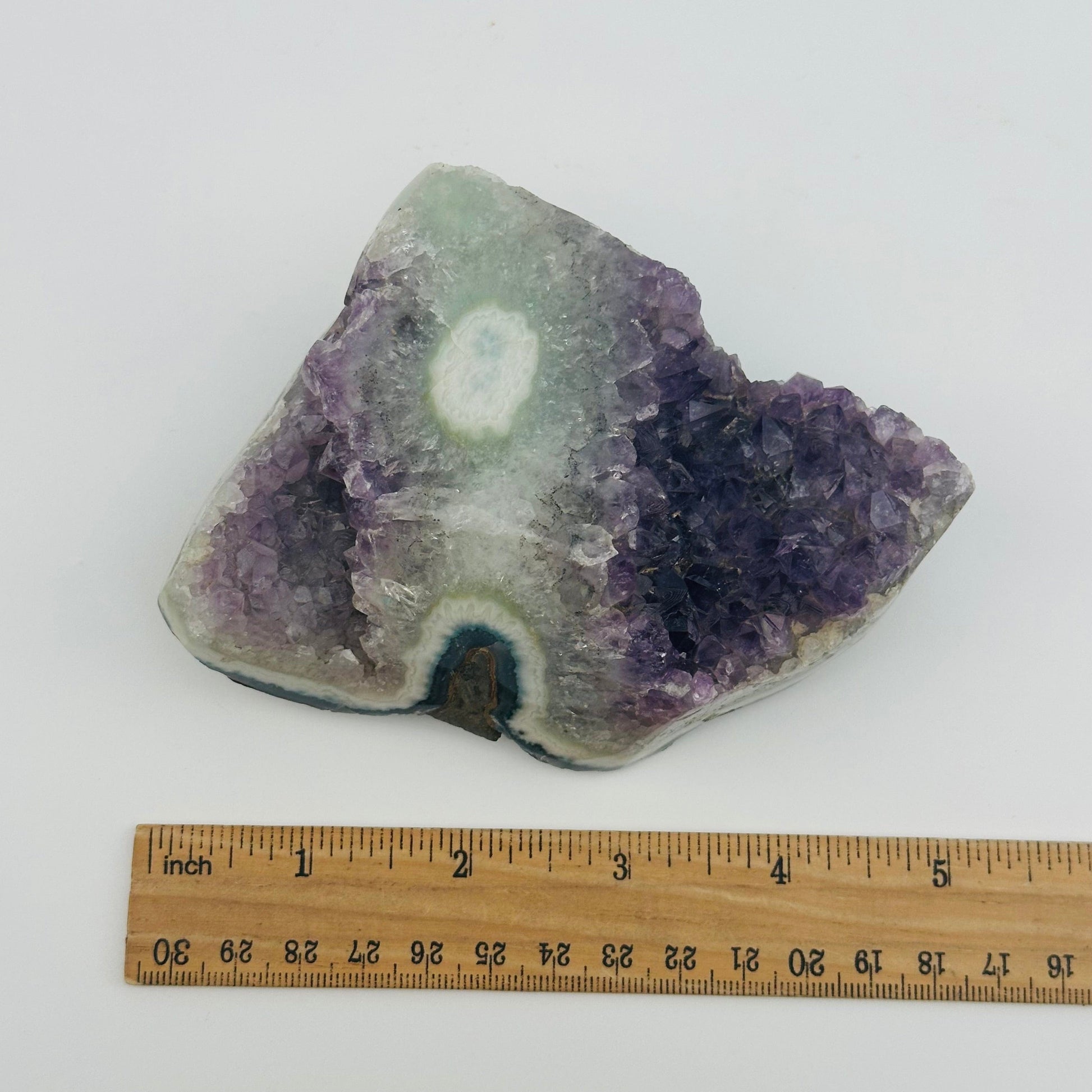 crystal cluster next to a ruler for size reference 