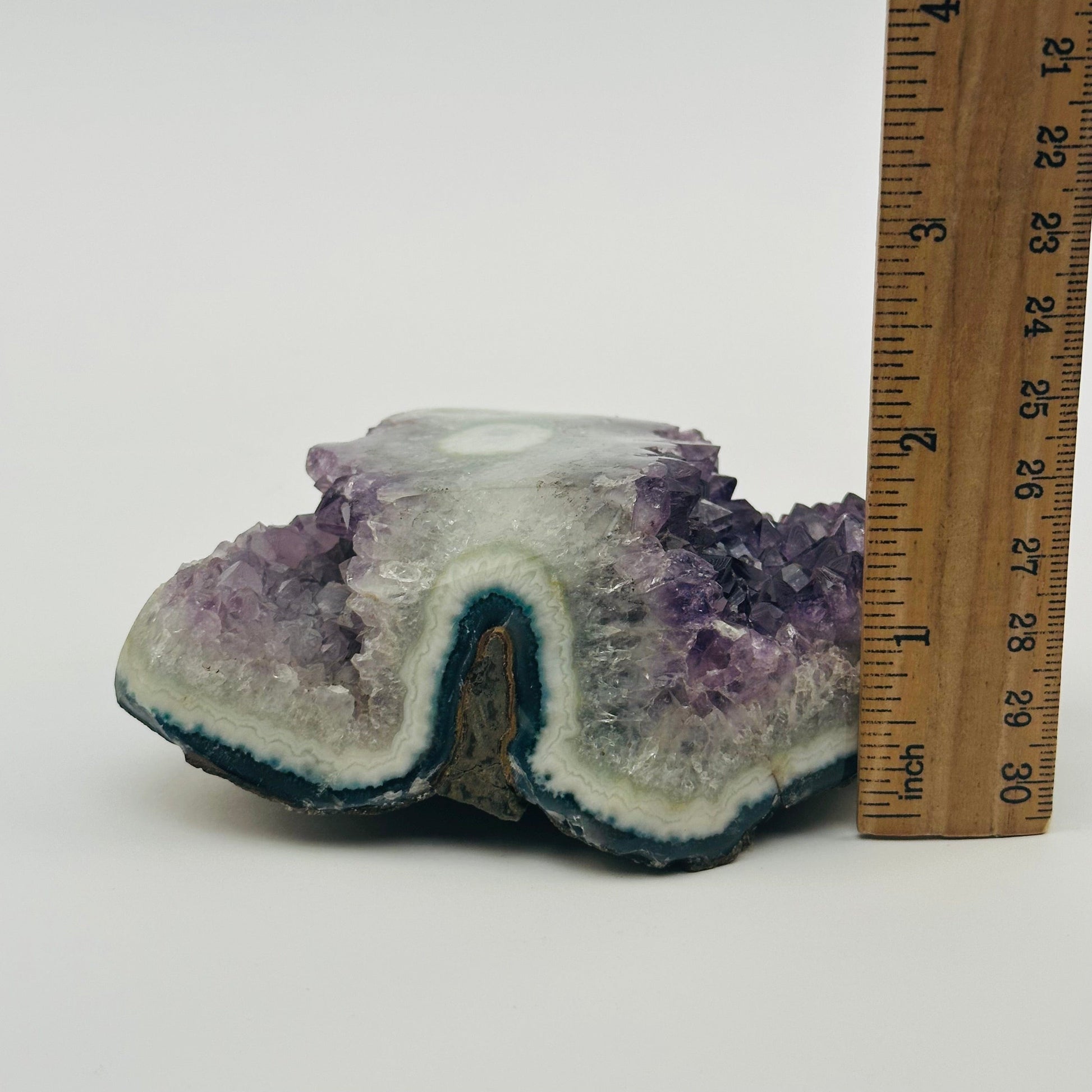 crystal cluster next to a ruler for size reference 