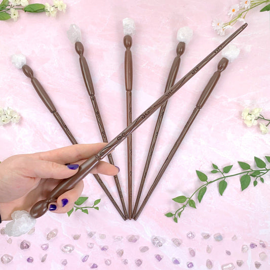 hand holding up White Geode - Enchantment Wand with others on pink background