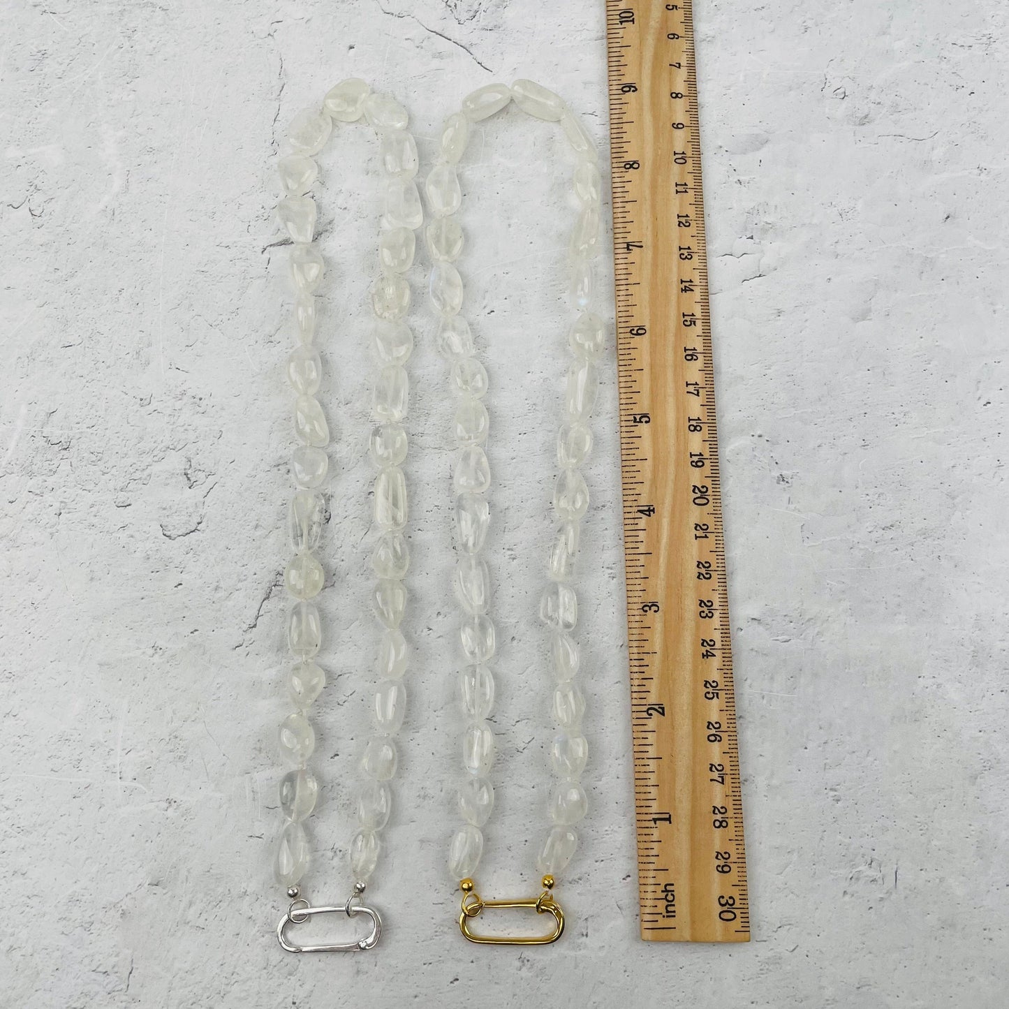 necklace next to a ruler for size reference 
