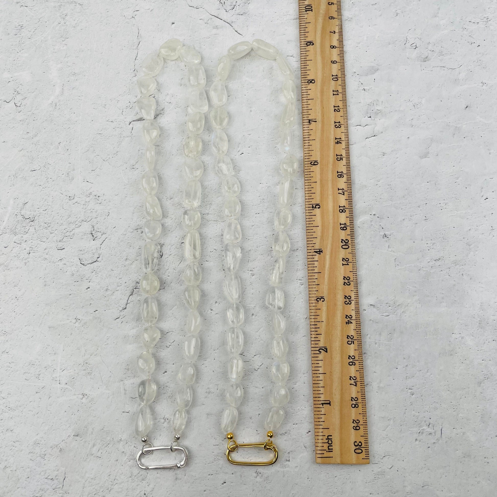 necklace next to a ruler for size reference 