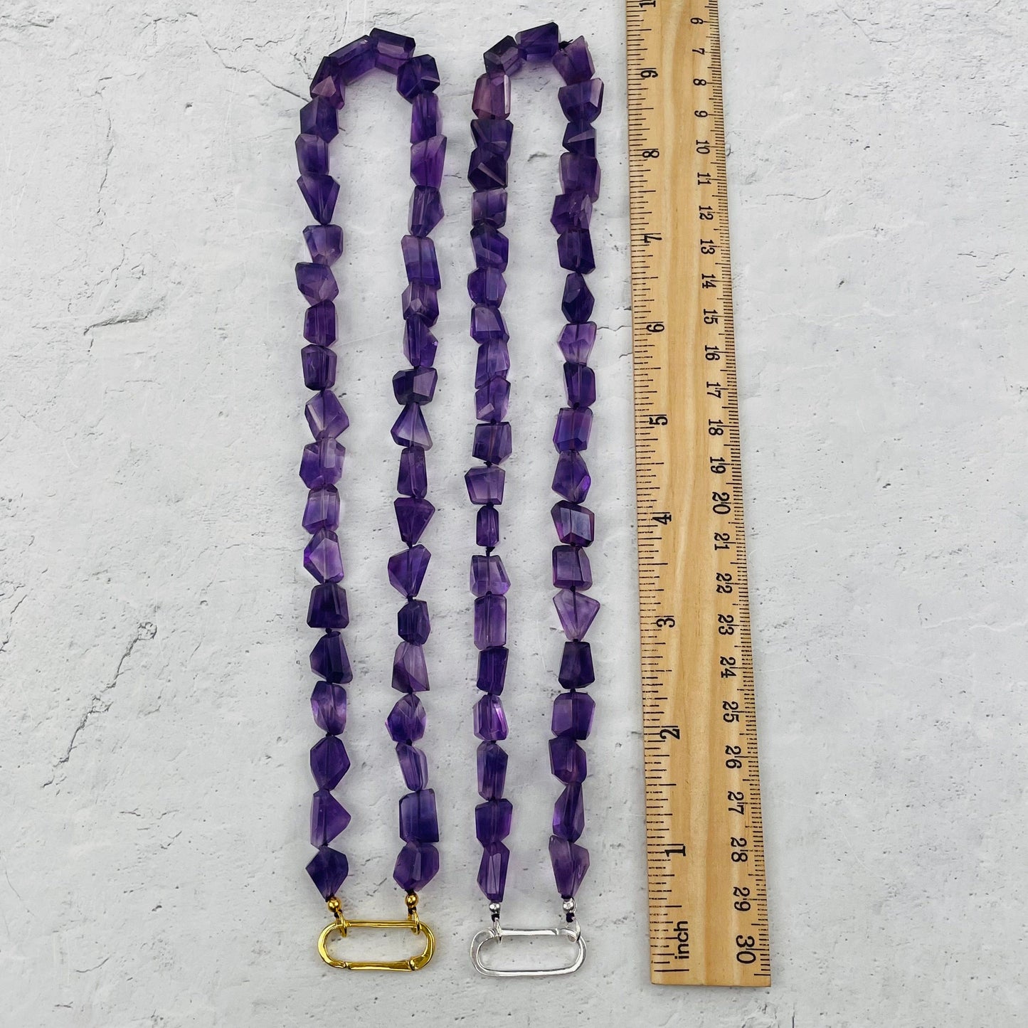 necklaces next to a ruler for size reference 
