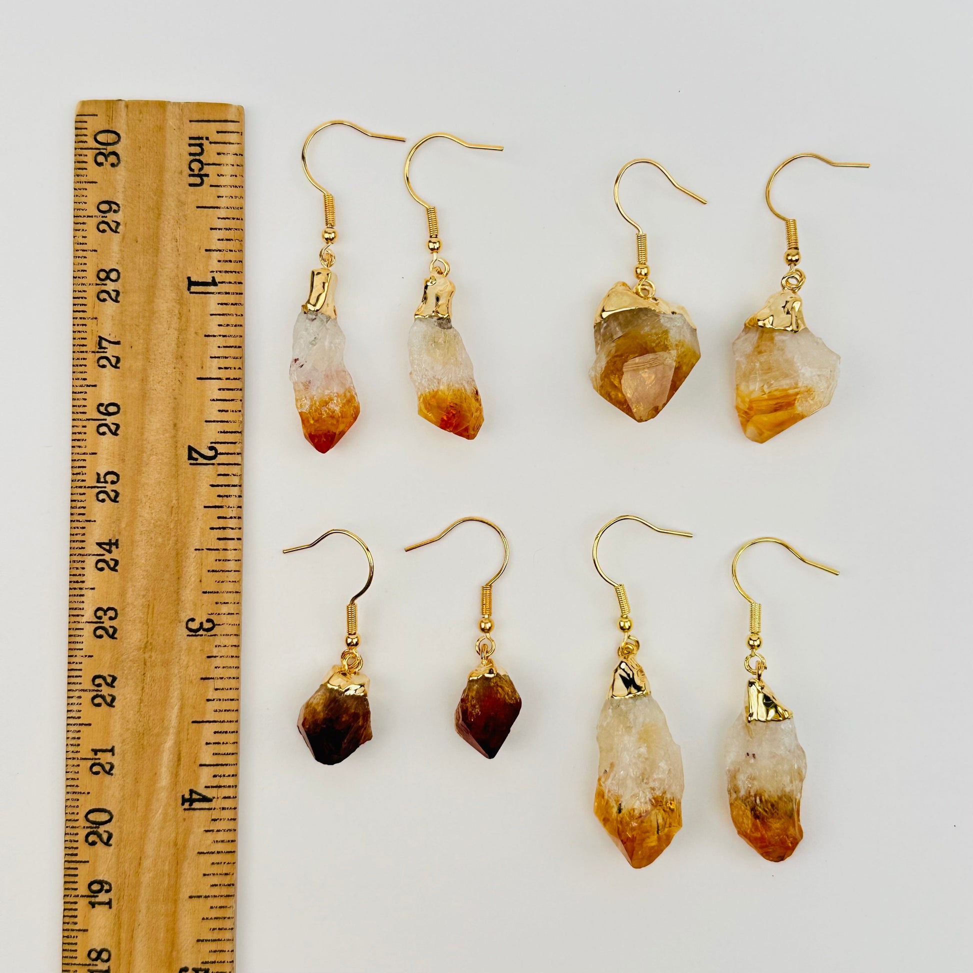earrings next to a ruler for size reference 