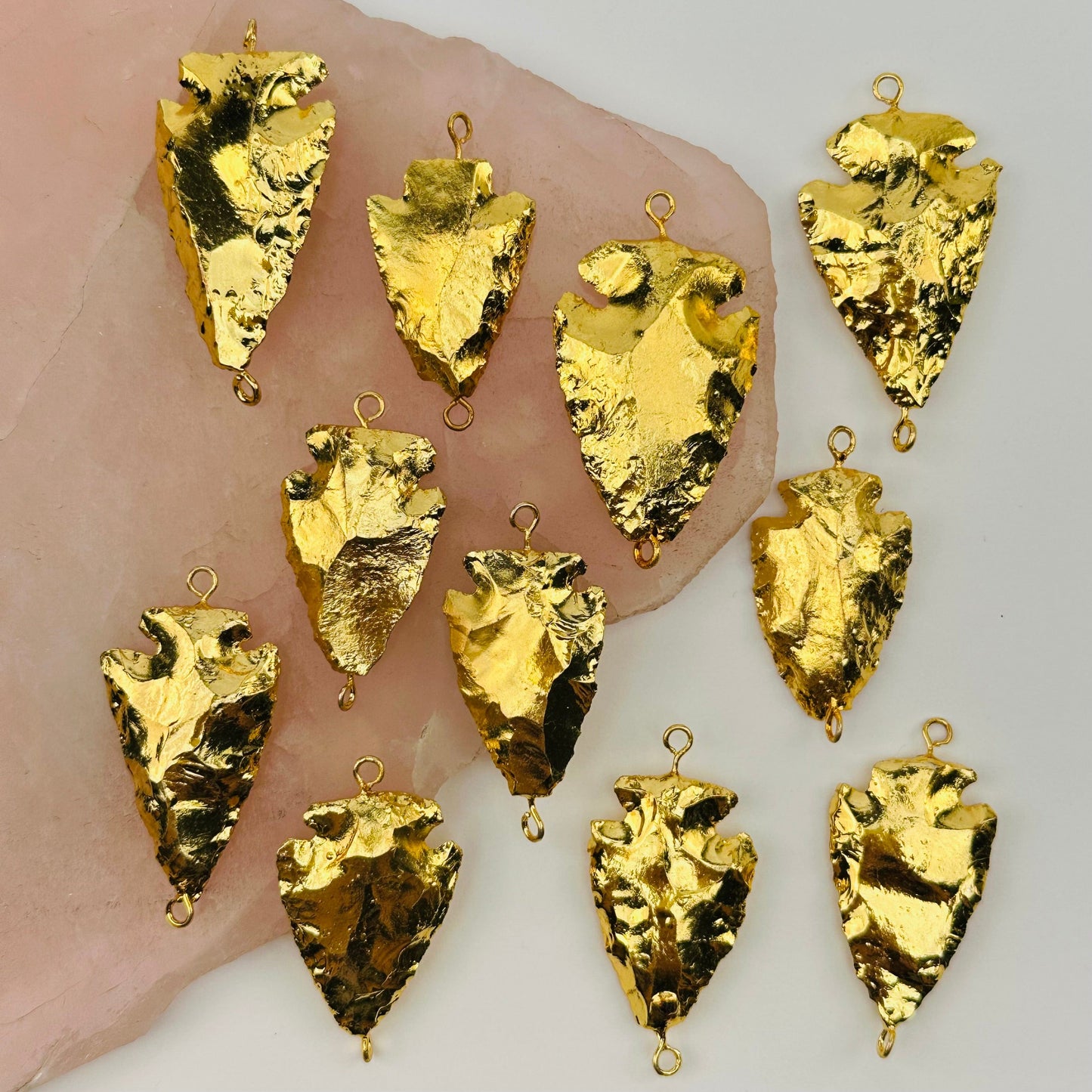 multiple double bail arrowhead charms displayed to show the differences in the sizes 