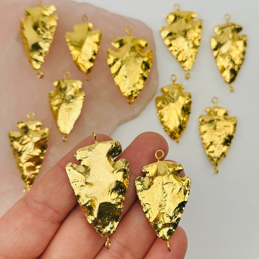 double bail arrowhead charms in hand for size reference 