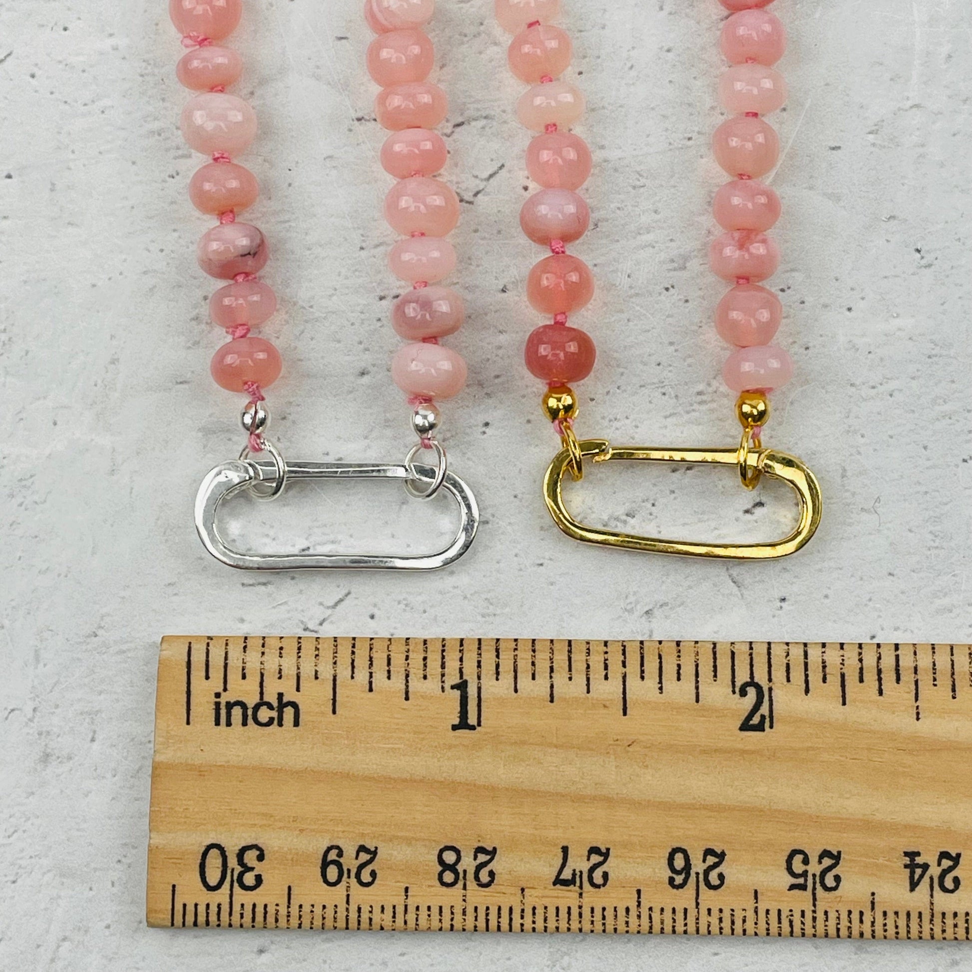 clasps next to a ruler for size reference 