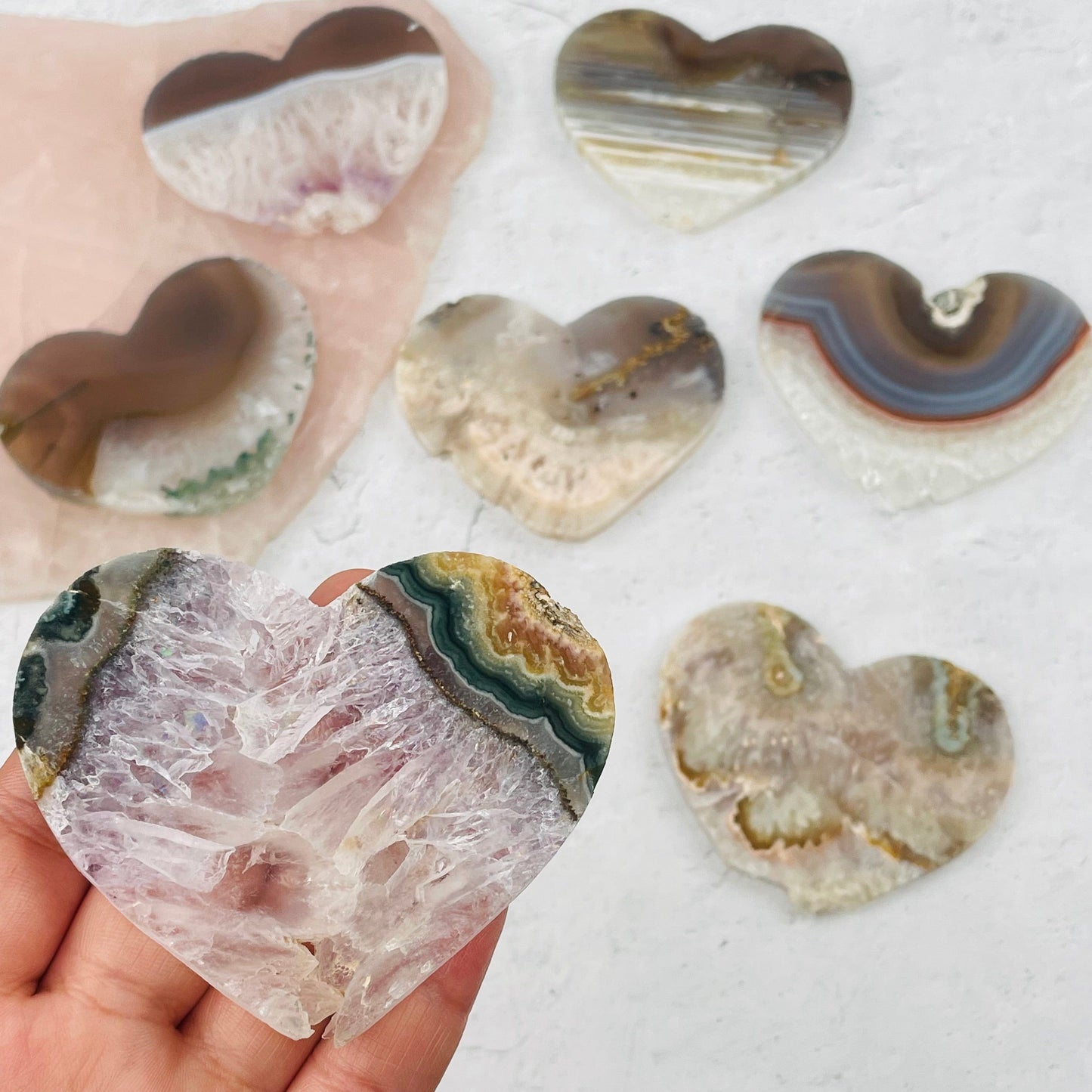 Amethyst Heart Slice in hand for size reference