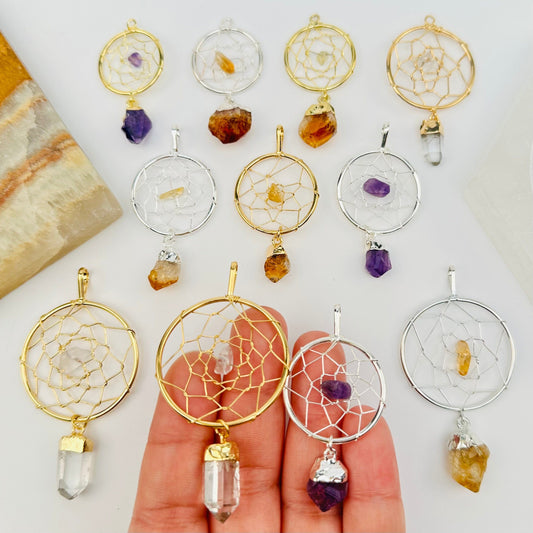 multiple dream catcher pendants displayed to show the differences in the sizes and crystal types 