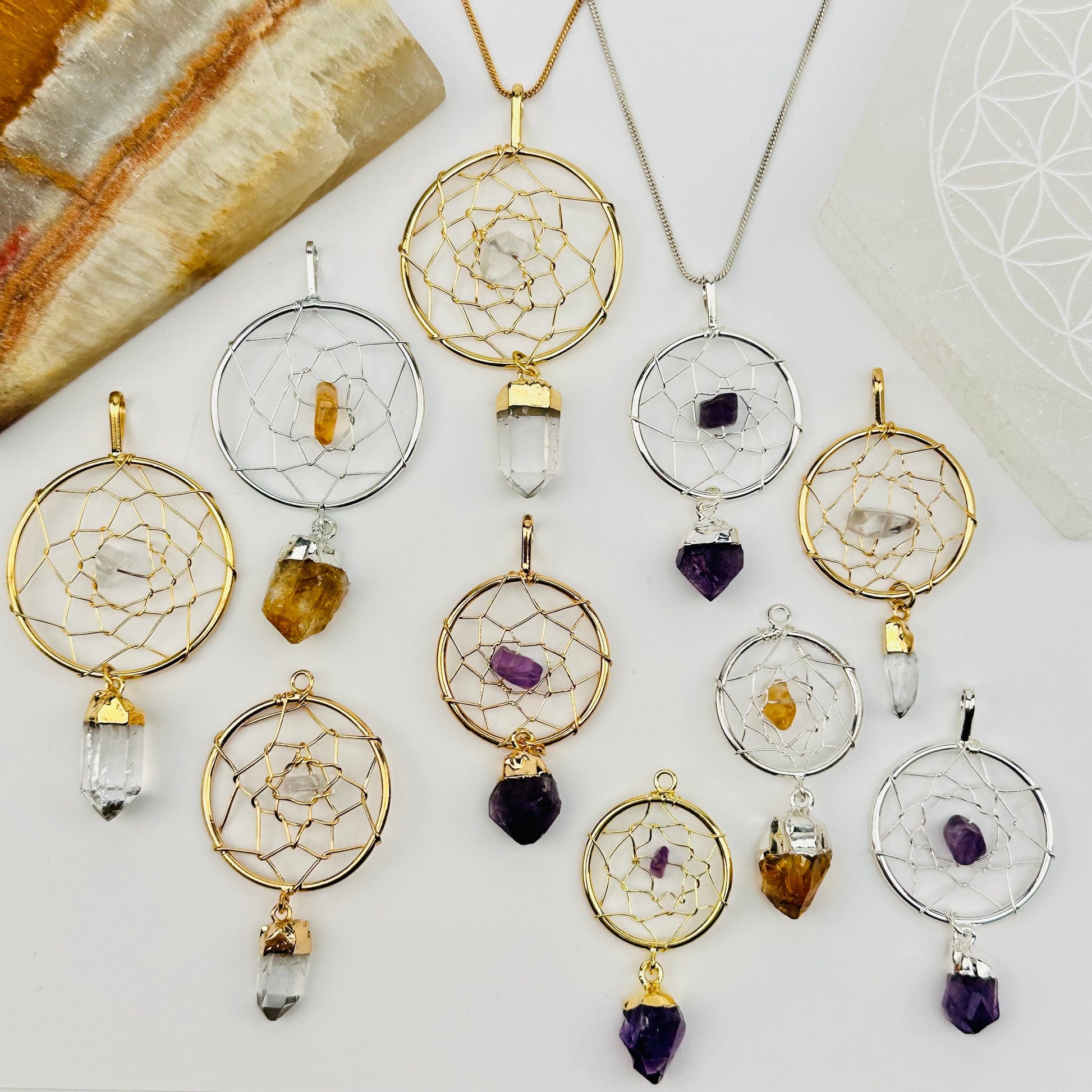 multiple dream catcher pendants displayed to show the differences in the sizes and crystal types 