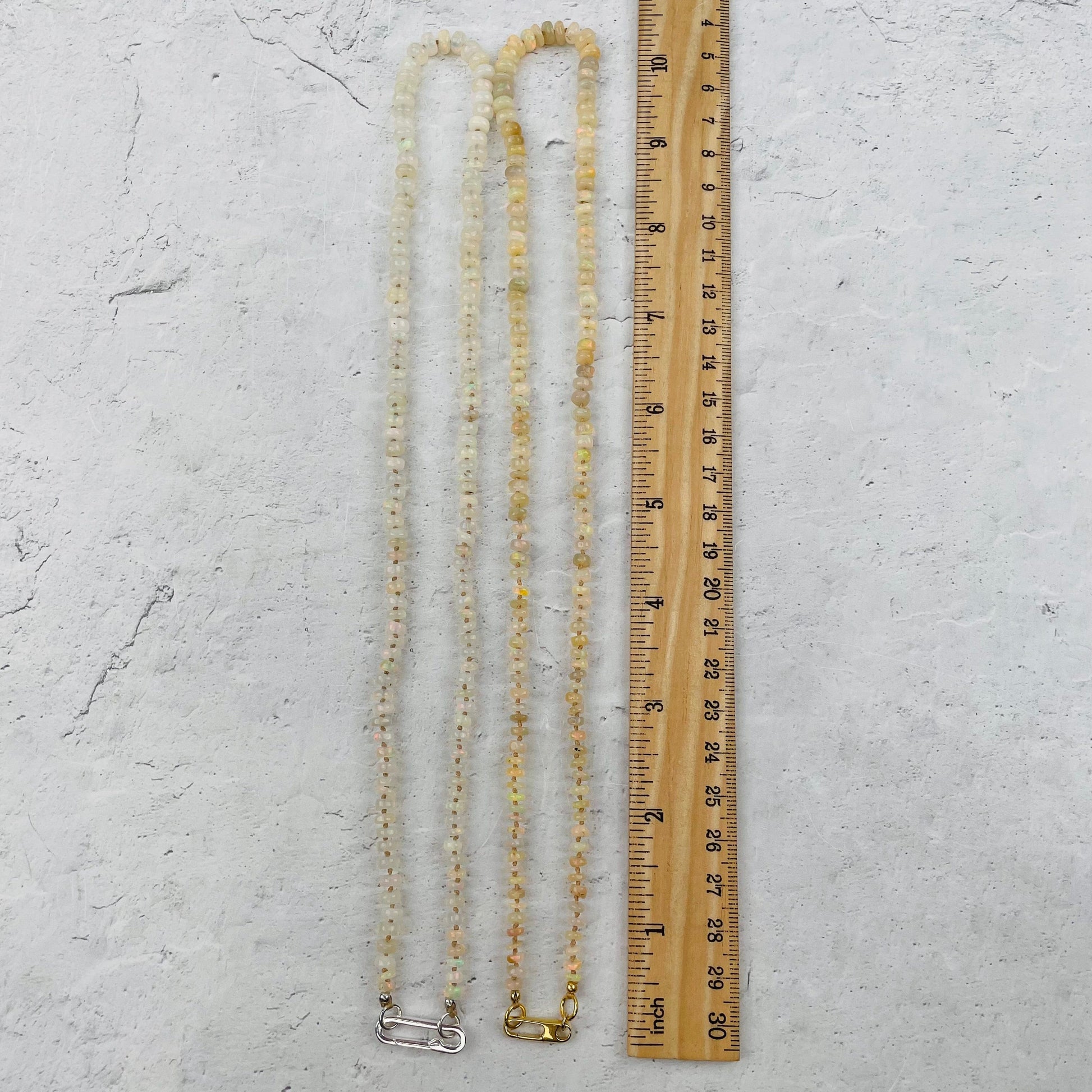 necklace next to a ruler for size reference 