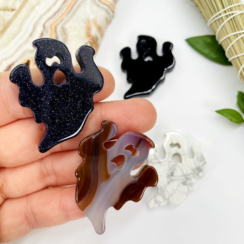 ghost gemstone cabochons in hand for size reference 