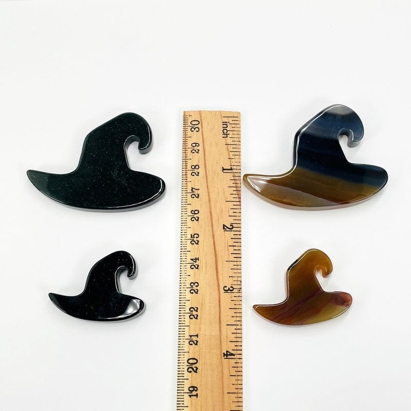 hats next to a ruler for size reference 