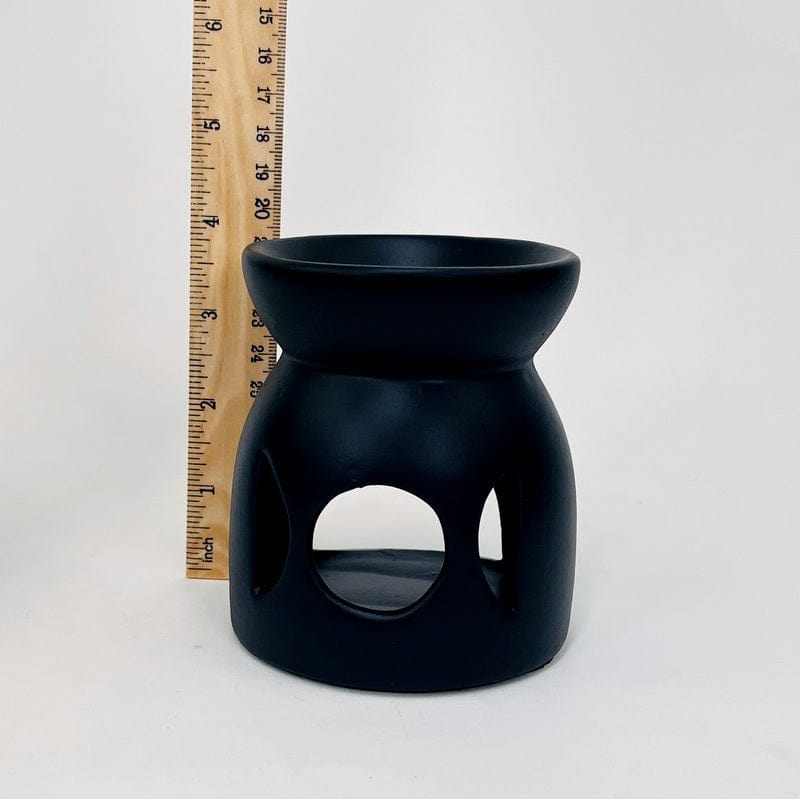 aroma burner next to a ruler for size reference 
