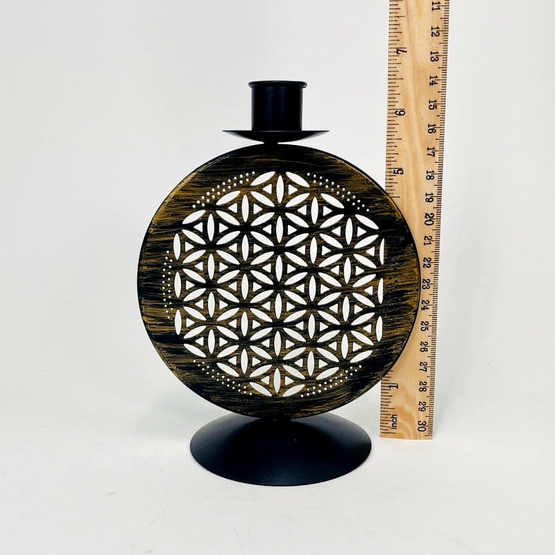 candle holder next to a ruler for size reference 