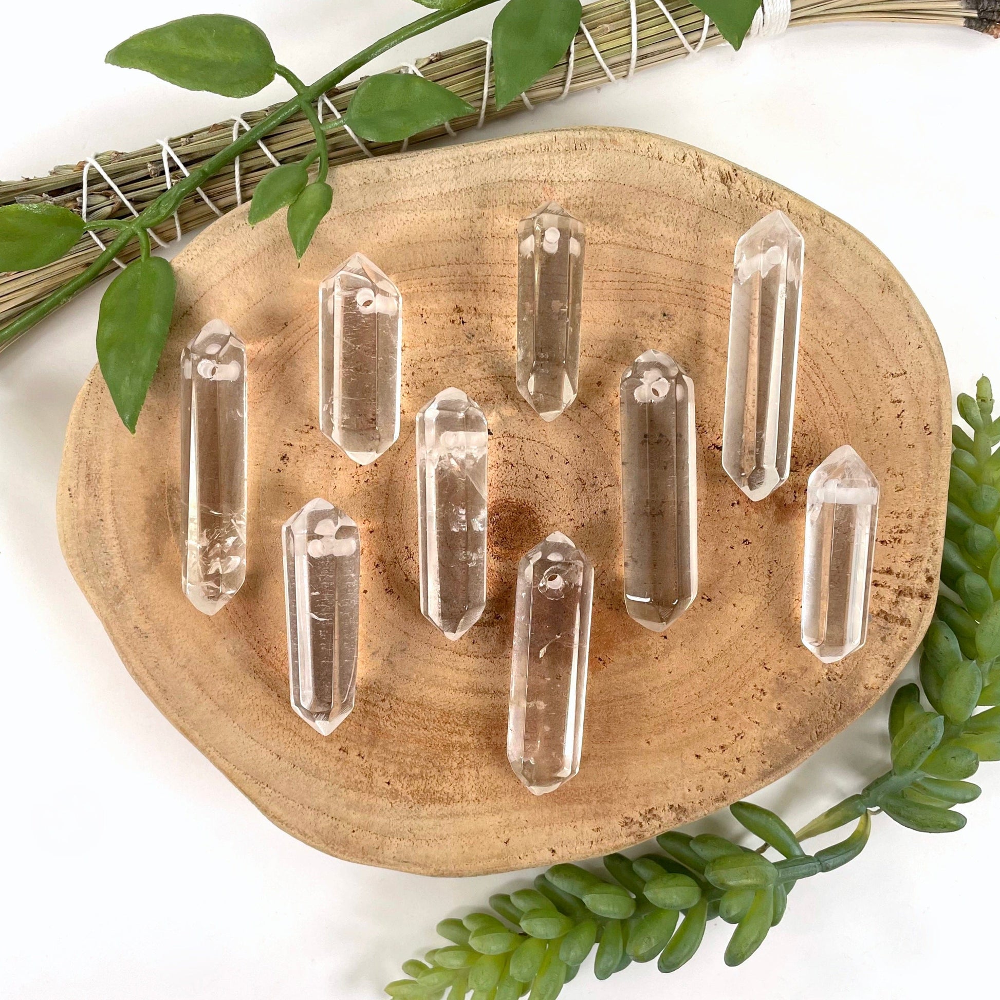 many drilled crystal quartz double points in display for possible variations