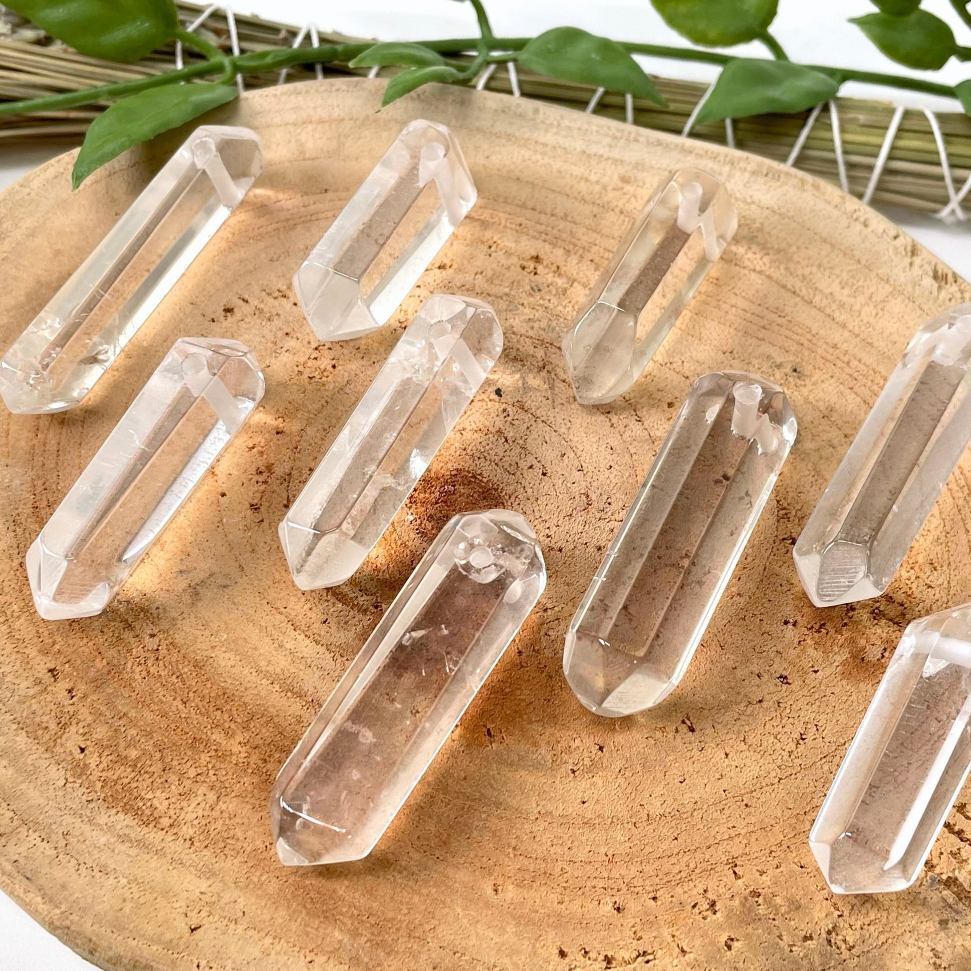 angled view of many drilled crystal quartz double points for thickness
