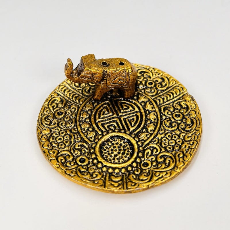 close up of the elephant burner in gold that can hold two incense sticks and a cone 